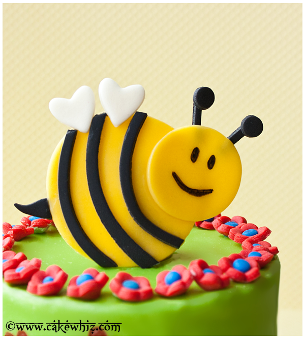 Closeup Shot of Fondant Bumblebee Cake Topper With Yellow Background